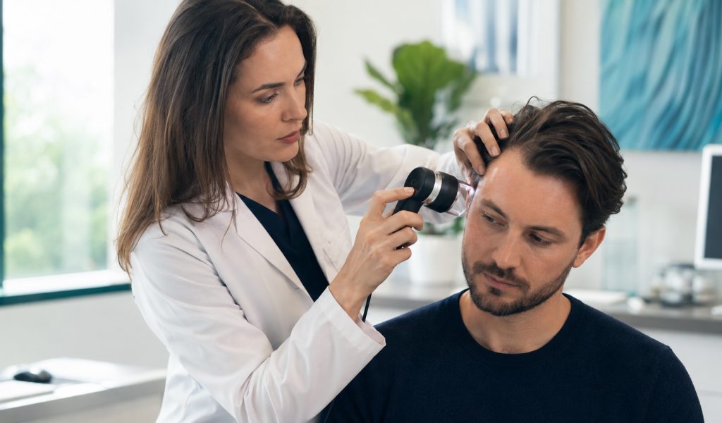 Medical scalp examination in bright clinic